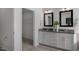 Elegant bathroom with double vanity, large mirrors, and walk-in shower at 2232 Cherry Top Dr, Fuquay Varina, NC 27526