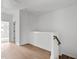 Upstairs hallway with hardwood floors and access to bedrooms at 6402 Tanner Oak Ln, Raleigh, NC 27613