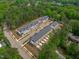 Aerial view of townhome community nestled in a wooded area at 6402 Tanner Oak Ln, Raleigh, NC 27613