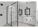 Modern bathroom with double vanity, frameless shower, and window at 6408 Tanner Oak Ln, Raleigh, NC 27613