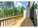 Deck with wooden railings offering backyard and neighborhood views at 6408 Tanner Oak Ln, Raleigh, NC 27613