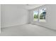 Well-lit bedroom with neutral carpet and two windows at 6408 Tanner Oak Ln, Raleigh, NC 27613