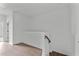 Upstairs hallway with wood floors and access to bedrooms at 6408 Tanner Oak Ln, Raleigh, NC 27613