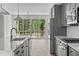 Modern kitchen features stainless steel appliances and access to a deck at 6408 Tanner Oak Ln, Raleigh, NC 27613