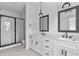 Elegant bathroom with double vanity, black accents, and a walk-in shower at 6408 Tanner Oak Ln, Raleigh, NC 27613