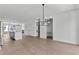 Open concept dining room with hardwood floors and modern chandelier at 6408 Tanner Oak Ln, Raleigh, NC 27613
