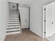 Modern staircase with wood steps and black metal railing at 6408 Tanner Oak Ln, Raleigh, NC 27613