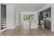Open concept living area with hardwood floors and stairs to upper level at 6408 Tanner Oak Ln, Raleigh, NC 27613