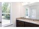 Double vanity bathroom with granite countertops and large mirror at 130 Charlie Cir, Angier, NC 27501