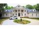 Two-story brick home with circular driveway, landscaping, and a white SUV at 5200 Blue Stem Ct, Raleigh, NC 27606