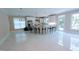 Modern kitchen with island, white cabinets, and large windows at 5200 Blue Stem Ct, Raleigh, NC 27606
