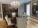 Spacious dining room with a wine cellar and modern chandelier at 5200 Blue Stem Ct, Raleigh, NC 27606