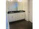 Bathroom with double vanity and dark countertops at 5200 Blue Stem Ct, Raleigh, NC 27606