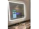 Modern bathroom with a sleek smart mirror and marble countertops at 5200 Blue Stem Ct, Raleigh, NC 27606