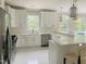 Spacious kitchen with white cabinets, quartz countertops, and stainless steel appliances at 5200 Blue Stem Ct, Raleigh, NC 27606