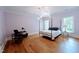 Spacious bedroom with hardwood floors, large windows and a desk area at 5200 Blue Stem Ct, Raleigh, NC 27606