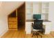 Bright bonus room with hardwood floors, built-in shelving and a workspace at 5200 Blue Stem Ct, Raleigh, NC 27606