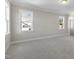 Spacious bedroom with grey carpet and multiple windows at 210 Colvard Farms Rd, Durham, NC 27713