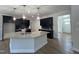 Modern kitchen with dark cabinetry, granite countertops and island, open to the dining area at 109 Godwin Ct, Sanford, NC 27330