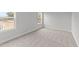 Bedroom with neutral walls, carpet, and a window with wooded views at 110 Merrifield Ln, Garner, NC 27529