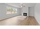 Living room with hardwood floors, fireplace, and ceiling fan at 110 Merrifield Ln, Garner, NC 27529