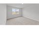 Bright bedroom with carpeted floor and a large window at 110 Merrifield Ln, Garner, NC 27529