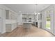 Modern kitchen with island, white cabinets, and stainless steel appliances at 110 Merrifield Ln, Garner, NC 27529