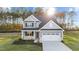 Two-story home with gray siding, white trim, and landscaping at 110 Merrifield Ln, Garner, NC 27529