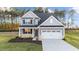Two-story home with gray siding, white trim, and landscaping at 110 Merrifield Ln, Garner, NC 27529
