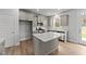 Modern kitchen with gray cabinets, quartz countertops, and stainless steel appliances at 110 Merrifield Ln, Garner, NC 27529