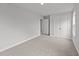 Bright bedroom with carpeted floor and double doors to closet at 110 Merrifield Ln, Garner, NC 27529