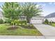 House exterior featuring gray siding, white garage door, and landscaping at 258 Tyree Trl, Burlington, NC 27215