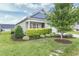 Landscaped front yard with green grass and manicured bushes at 258 Tyree Trl, Burlington, NC 27215