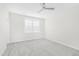 Well-lit bedroom with grey carpet and ceiling fan at 258 Tyree Trl, Burlington, NC 27215