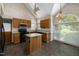 Kitchen features granite countertops, wood cabinets, and a kitchen island at 2517 Oakes Plantation Dr, Raleigh, NC 27610