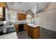 Bright eat-in kitchen with granite counters and wood cabinets at 2517 Oakes Plantation Dr, Raleigh, NC 27610