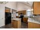 This kitchen boasts granite countertops and dark wood cabinets at 2517 Oakes Plantation Dr, Raleigh, NC 27610
