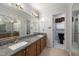 Bathroom features double sinks, granite countertops, and a large mirror at 2517 Oakes Plantation Dr, Raleigh, NC 27610