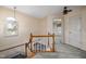Upstairs hallway with wood railing and carpet at 2517 Oakes Plantation Dr, Raleigh, NC 27610