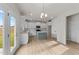 Modern kitchen with island and white cabinets at 90 Merrifield Ln, Garner, NC 27529