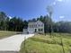Two-story house with light beige siding, two-car garage, and a landscaped yard at 321 Constellation Ct, Benson, NC 27504