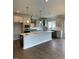 Modern kitchen with large island and stainless steel appliances at 317 Kavanaugh Rd, Wake Forest, NC 27587