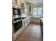 Modern kitchen with white cabinets, stainless steel appliances, and farmhouse sink at 317 Kavanaugh Rd, Wake Forest, NC 27587