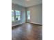 Bright living room with hardwood floors and multiple windows at 317 Kavanaugh Rd, Wake Forest, NC 27587
