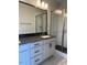 Modern bathroom with a double vanity, large mirror, and glass shower at 317 Kavanaugh Rd, Wake Forest, NC 27587