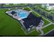 Aerial view of resort-style pool with cabana and surrounding green space at 116 Augusta Pond Way # 140, Raleigh, NC 27603