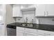 Modern kitchen with white cabinets, granite countertops, and stainless steel appliances at 222 Glenwood Ave # 307, Raleigh, NC 27603
