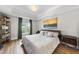 Main bedroom with king-size bed, large windows, and wood floors at 222 Glenwood Ave # 307, Raleigh, NC 27603