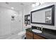 Modern bathroom with subway tile shower and dark granite vanity at 222 Glenwood Ave # 307, Raleigh, NC 27603