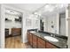 Double vanity bathroom with granite countertop and walk-in closet at 222 Glenwood Ave # 307, Raleigh, NC 27603